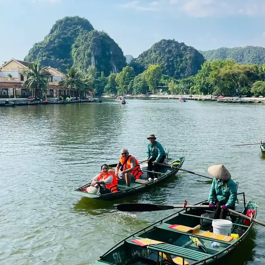 Guests on a rowing boat at Tam Coc, Ninh Binh